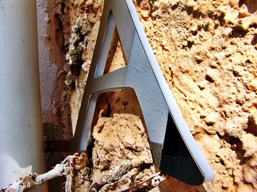 Detail of cut letter mixed in methacrylate with steel